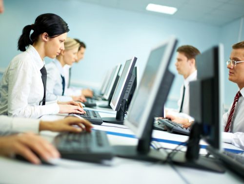 Office with white collar workers working on computers